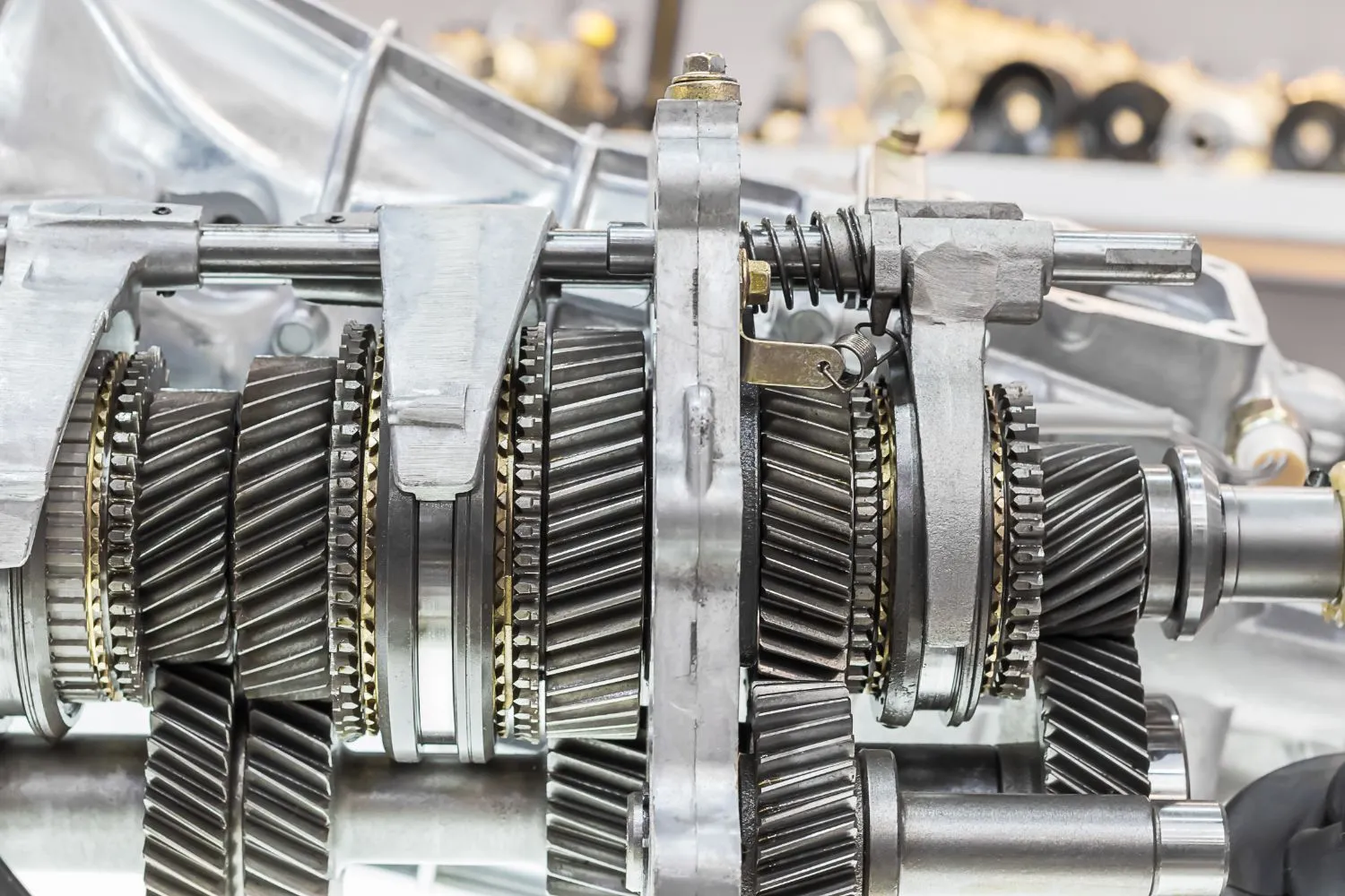 Gear sets and shift forks inside a disassembled gearbox